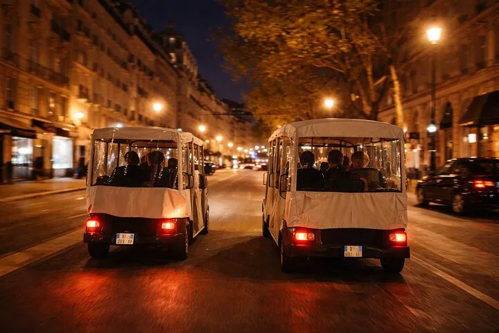 Two ParisAdventour golf carts at night in Paris